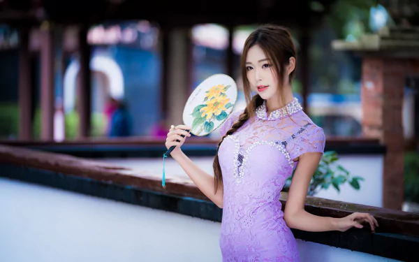 Asian woman with brunette braid and brown eyes wears a purple dress, holding a decorative fan, captured with depth of field in a 4K Ultra HD PC desktop wallpaper.