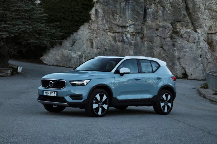 A silver Volvo XC40 SUV parked on a mountainous road, captured in stunning 4K Ultra HD quality for a PC desktop wallpaper background.