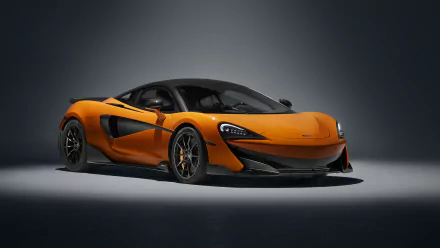 Orange McLaren 600LT supercar showcased in a high-resolution 4K Ultra HD desktop wallpaper, highlighting its sleek design and dynamic presence.