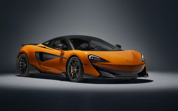 Orange McLaren 600LT supercar showcased in a high-resolution 4K Ultra HD desktop wallpaper, highlighting its sleek design and dynamic presence.