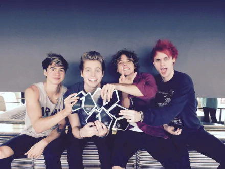 HD desktop wallpaper of 5 Seconds Of Summer, featuring the band members posing together with a playful demeanor.