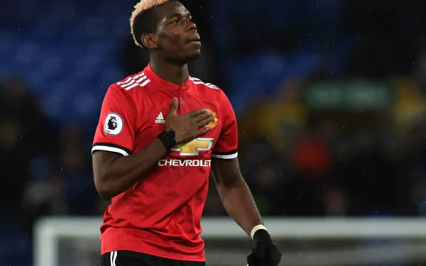 HD wallpaper featuring Paul Pogba in a Manchester United kit, suitable as a desktop background.