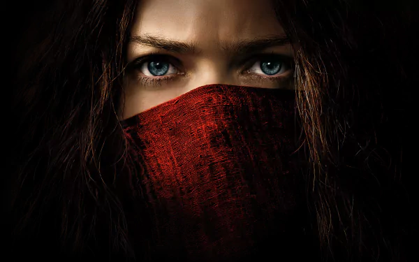 Close-up of Hera Hilmar from the movie Mortal Engines, featuring intense blue eyes and a red mask, designed as an HD PC desktop wallpaper and background.