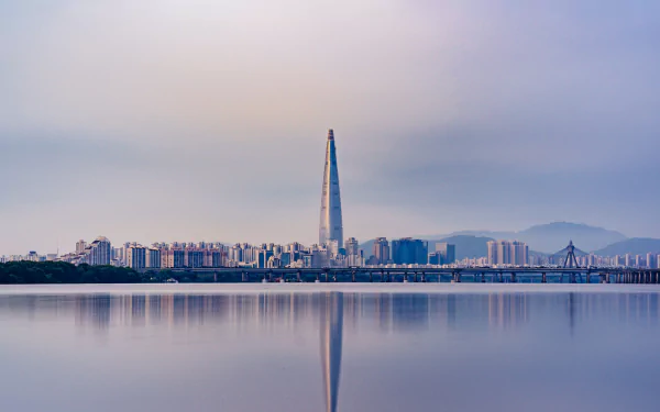 4K Ultra HD wallpaper of Seoul’s skyline featuring the Lotte World Tower skyscraper reflected in calm waters, showcasing modern city architecture in South Korea.