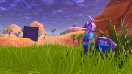 HD Fortnite Battle Royale PC wallpaper featuring the iconic llama piñata in a grassy desert landscape under a dramatic purple sky.