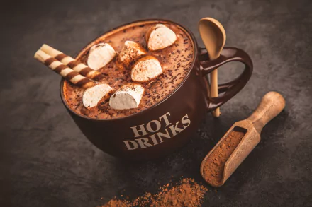 HD desktop wallpaper featuring a still life of a cup of hot chocolate topped with marshmallows and wafer sticks, accompanied by a scoop of cocoa powder.