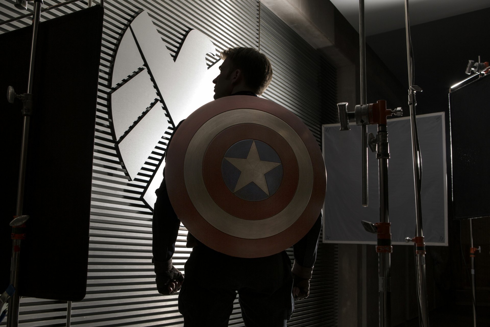 Chris Evans as Captain America from Captain America: The Winter Soldier, featured in a 4K Ultra HD PC desktop wallpaper with the iconic shield and SHIELD emblem backdrop.
