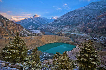A stunning HD desktop wallpaper of Banff National Park in Canada, showcasing a serene lake surrounded by rugged mountains and a canyon, highlighting the breathtaking beauty of nature.