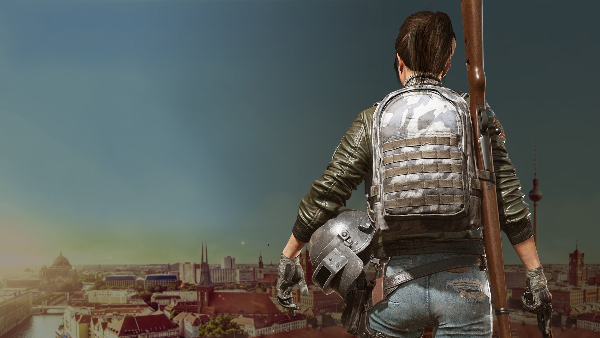 A PlayerUnknown's Battlegrounds character with a backpack and rifle overlooks a cityscape, featured in an HD desktop wallpaper background.