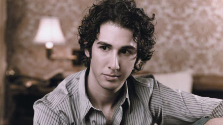 HD desktop wallpaper featuring a black and white portrait of a man with curly hair in a striped shirt, tagged as Josh Groban.