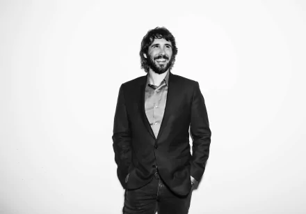 HD wallpaper and background featuring a monochrome portrait of a smiling man in a suit.