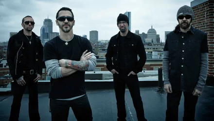 HD desktop wallpaper featuring Shinedown with four members standing confidently on a rooftop against a city skyline background.