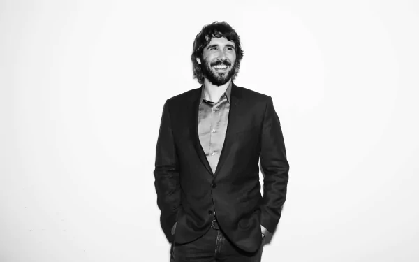 HD wallpaper and background featuring a monochrome portrait of a smiling man in a suit.