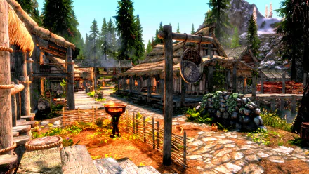 HD PC desktop wallpaper from The Elder Scrolls V: Skyrim showing a detailed village scene with wooden buildings, stone paths, and forested mountains in the background.