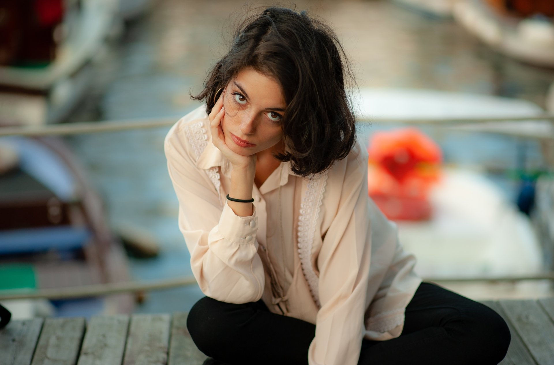 A brunette woman with black hair poses thoughtfully in a shallow depth of field portrait, captured in 4K Ultra HD as a PC desktop wallpaper.