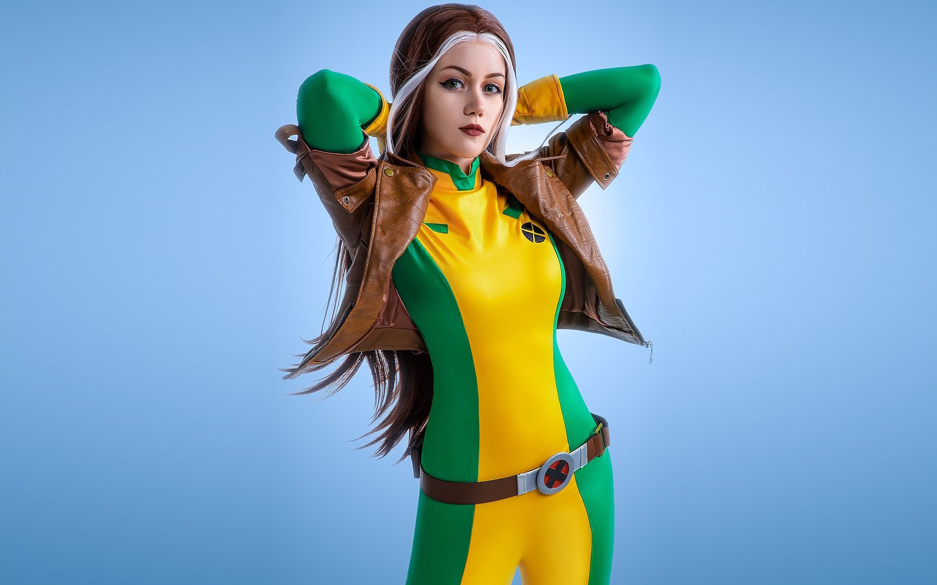 HD PC desktop wallpaper featuring a woman cosplaying as Rogue from Marvel Comics in her classic yellow and green outfit with a brown jacket.