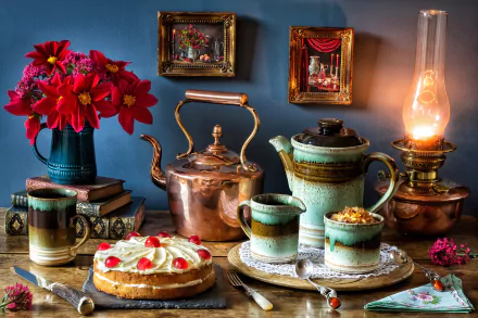 A 4K Ultra HD still life featuring a copper teapot, ceramic cups, cake, flowers, vintage lantern, knives, spoons, and framed paintings on a blue background.
