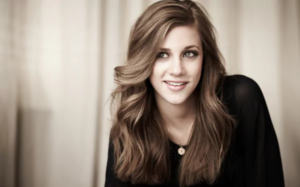 Close-up portrait of a smiling brunette woman, soft-lit head-and-shoulders composition with warm tones — 4K Ultra HD desktop wallpaper.