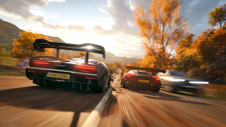 Screenshot from Forza Horizon 4 featuring high-speed racing cars on an autumn road, presented in 4K Ultra HD for PC desktop wallpaper.