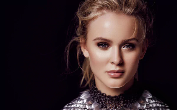 Close-up portrait of a blonde Swedish singer with light makeup and metallic top, captured in high detail for a 4K Ultra HD desktop wallpaper.