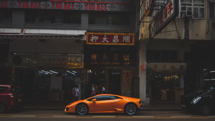 Orange Lamborghini Aventador vehicle parked on a Hong Kong street under neon signs — 5K Ultra HD PC desktop wallpaper and background.