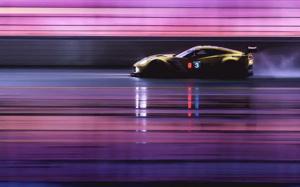 Side view of a Chevrolet Corvette racing at high speed, shown in motion blur with vibrant pink and purple lighting, featured as a 4K Ultra HD PC desktop wallpaper.