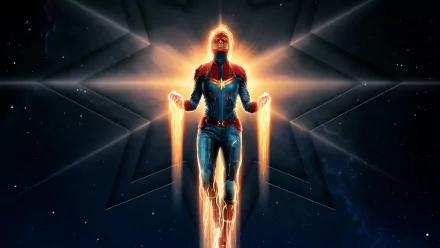 HD PC desktop wallpaper of Captain Marvel in a powerful glowing pose, set against a cosmic background with star-shaped light effects.