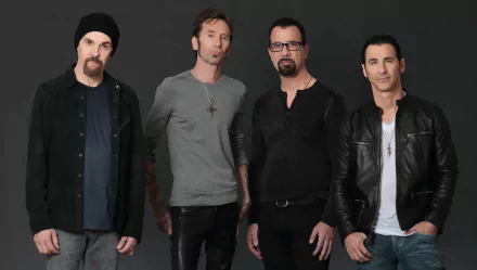 HD wallpaper featuring the band Godsmack posing together against a dark background for a desktop backdrop.