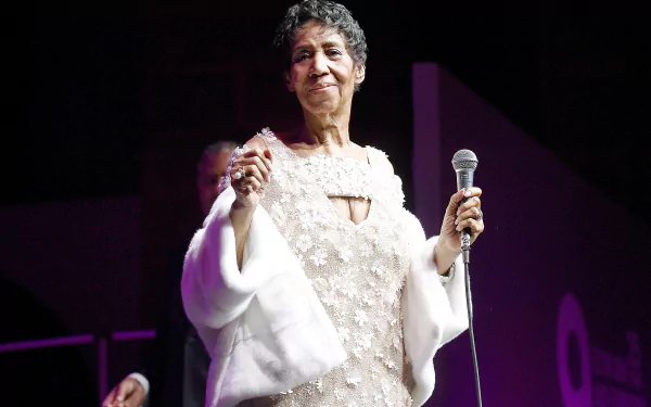 HD desktop wallpaper featuring a person on stage with a microphone, evoking the essence of a soulful performance.