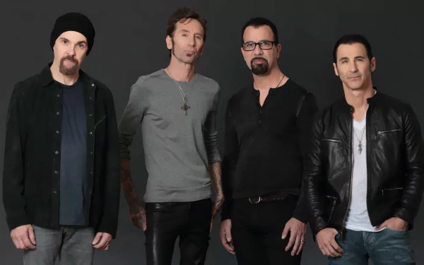HD wallpaper featuring the band Godsmack posing together against a dark background for a desktop backdrop.